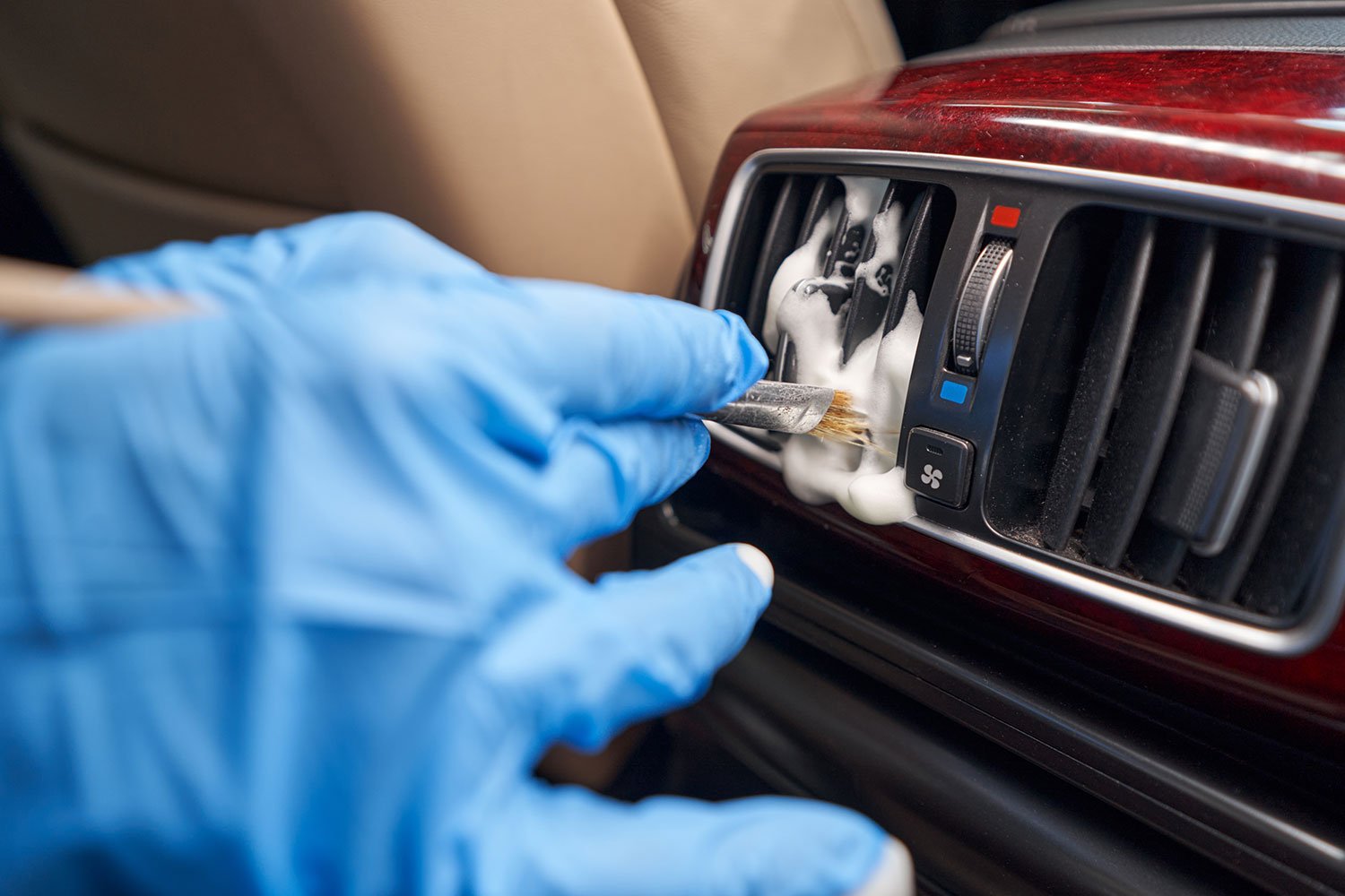 worker-cleaning-automobile-air-conditioner-vent-gr